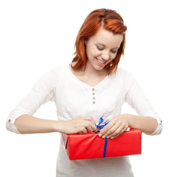 young beautiful red haired girl open present box in front of white background
