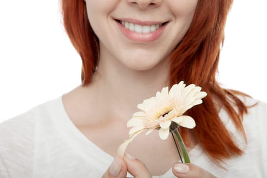 young beautiful red haired girl plays he loses me close up in front of white background