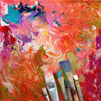 Different brushes with paint on painted background