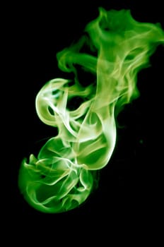 greenish fire with a black background, abstract background.