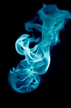 bluish fire with a black background, abstract background.