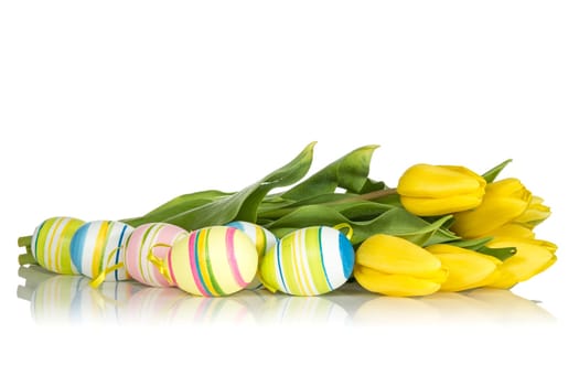 Yellow tulips and Easter eggs on the white background