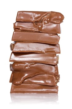 Melting chocolate pieces, isolated  on white background