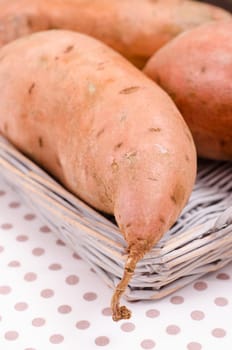 Raw sweet potatoes in a basket