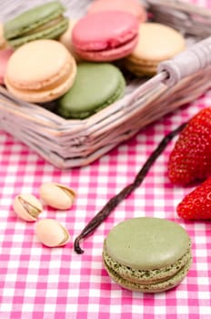 Green French macaron with pistachios in portrait format