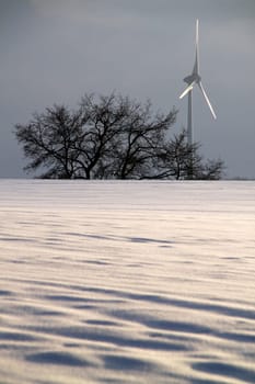 Winter landscape with wind turbine