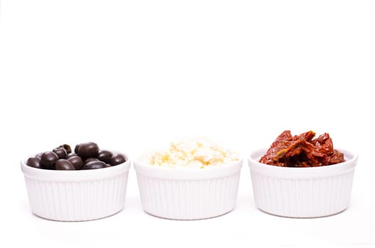 Olives,feta and dried tomatoes on a white background