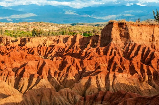 Red hills of Tatacoa Desert bathed in sunlight in Huila, Colombia