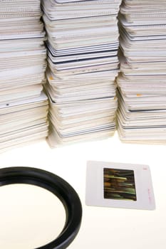 A Pile of Mounted Slide Film Sitting on The Lightbox with Loupe