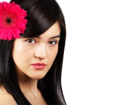 Portrait of a beautiful young woman with a flower in her hair isolated on white.