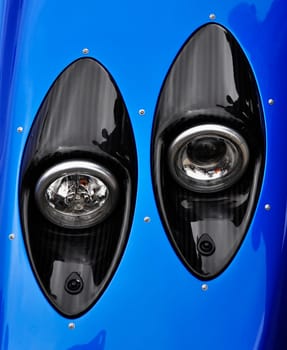 Supercar headlight, carbon fibre casing and blue bodywork