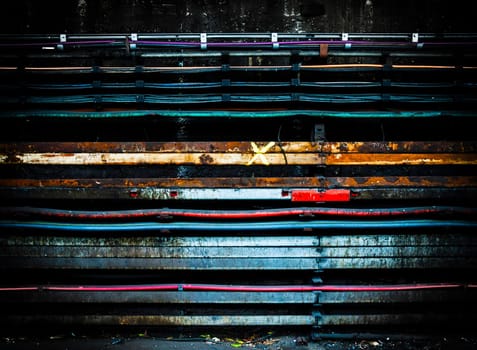 Electric cables on a grungy concrete wall with vignette