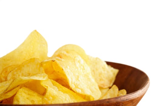 Crisps in a wooden bowl on white background