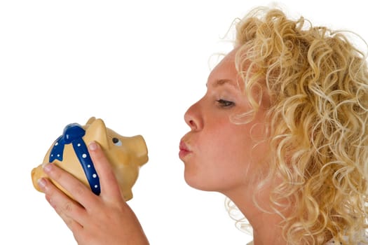 Young woman kissing her piggy bank isolated on white background