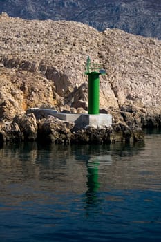 Little green lighthouse on sea