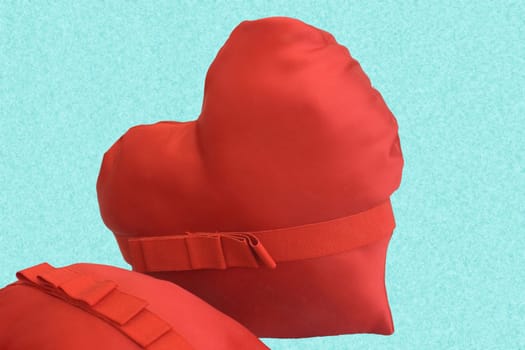 Heart pillows on cyan background
