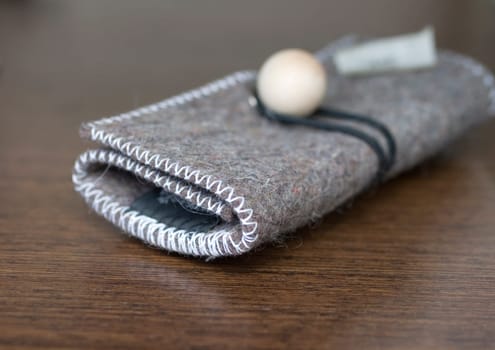Felt coin purse on a wood