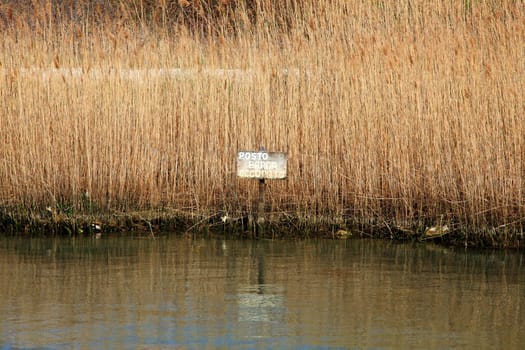 Sign on the river bank marked "Mooring busy"""