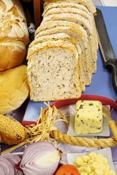 Sliced bread with selected rolls with herb butter ready to serve.