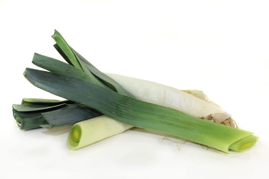 raw leeks against white background