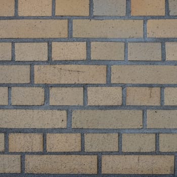 a yellow brickwall from an industry building