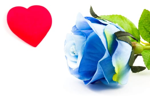 Blue rose and a heart on the background