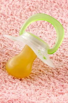 Pacifier on a pink towel