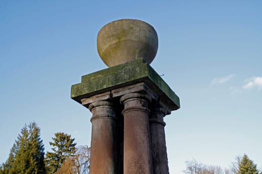 Column with vase in a park