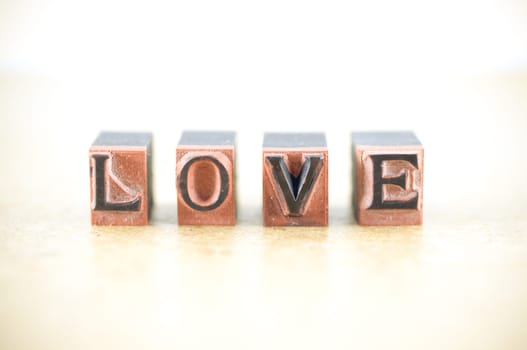 Word "love"" spelled out in letterpress letters."