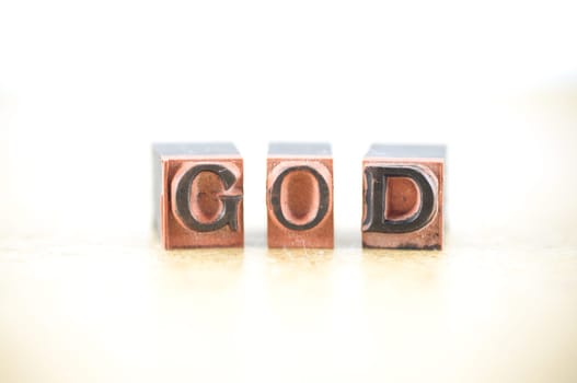 Word "God"" spelled out in letterpress letters."