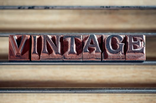 Word "vintage"" spelled out in letterpress letters."