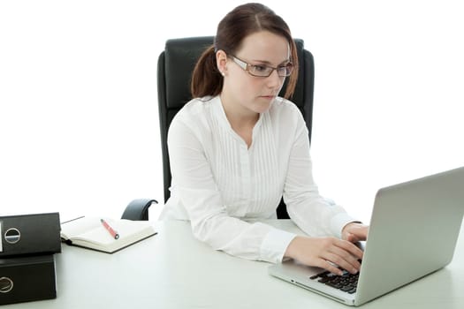 young brunette businesswoman with glasses working on laptop