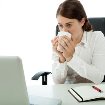 young brunette business woman drink coffee in front of computer