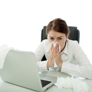 young brunette business woman is ill with hankies behind laptop