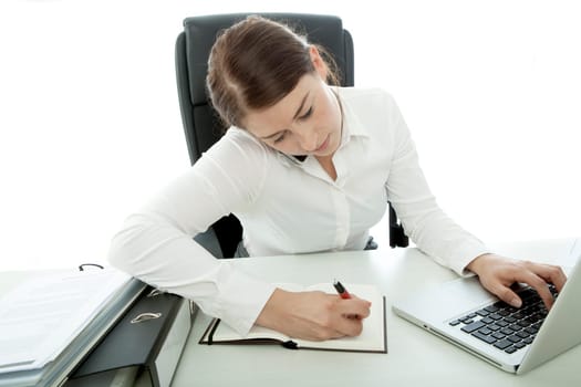 young brunette business woman busy with telefon and laptop
