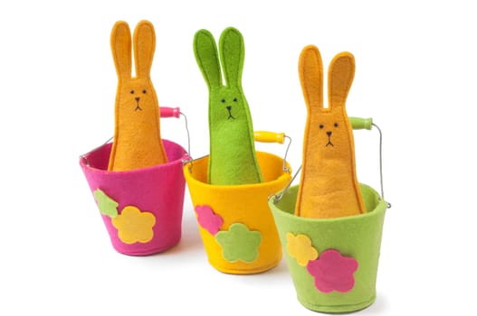 Multicolored easter bunnies sitting on the pots