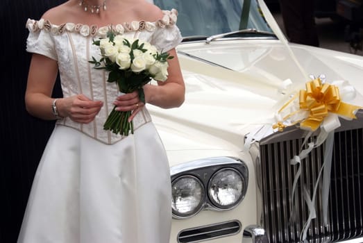 Bride by the classical car