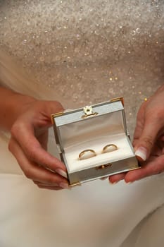 Bride holding little box with two wedding rings
