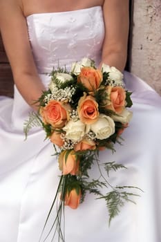 Bride in white dress holding wedding bouquet