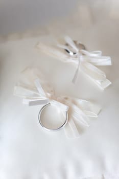 Wedding rings on white pillow