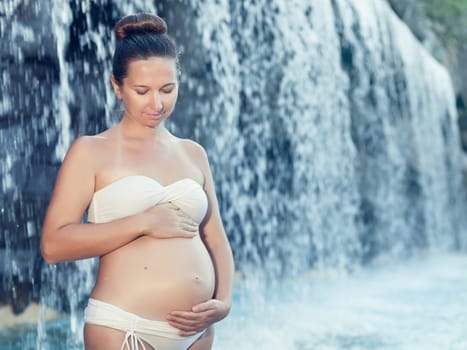 Beautiful pregnant woman in swimming pool