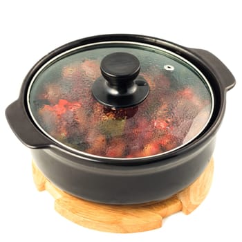 Beef and vegetables stewed in hot pot on white background