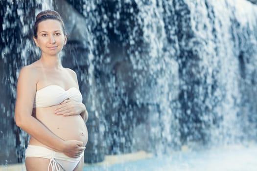 Beautiful pregnant woman in swimming pool