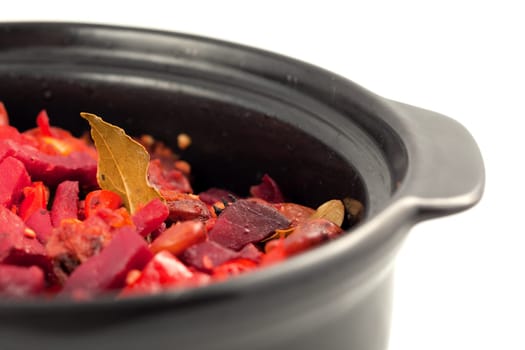 Beef and vegetables stewed in hot pot on white background