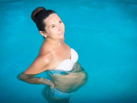 Beautiful pregnant woman in swimming pool
