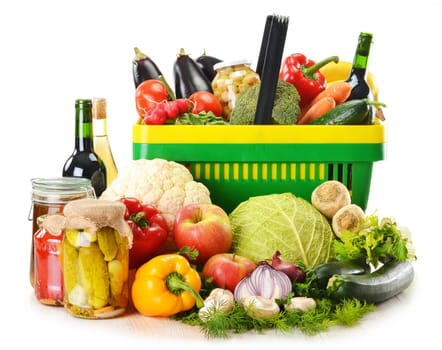 Composition with plastic shopping basket and grocery isolated on white
