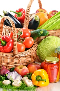 Composition with wicker basket and grocery isolated on white