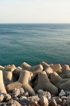 Concrete tetrapod  breakwater in the shore near Sesimbra, Portugal