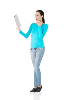 Young pretty woman working on tablet computer, isolated on white