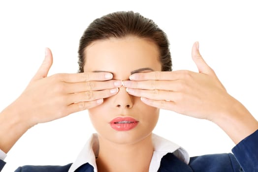 Attractive businesswoman covering her eyes with hands, isolated on white